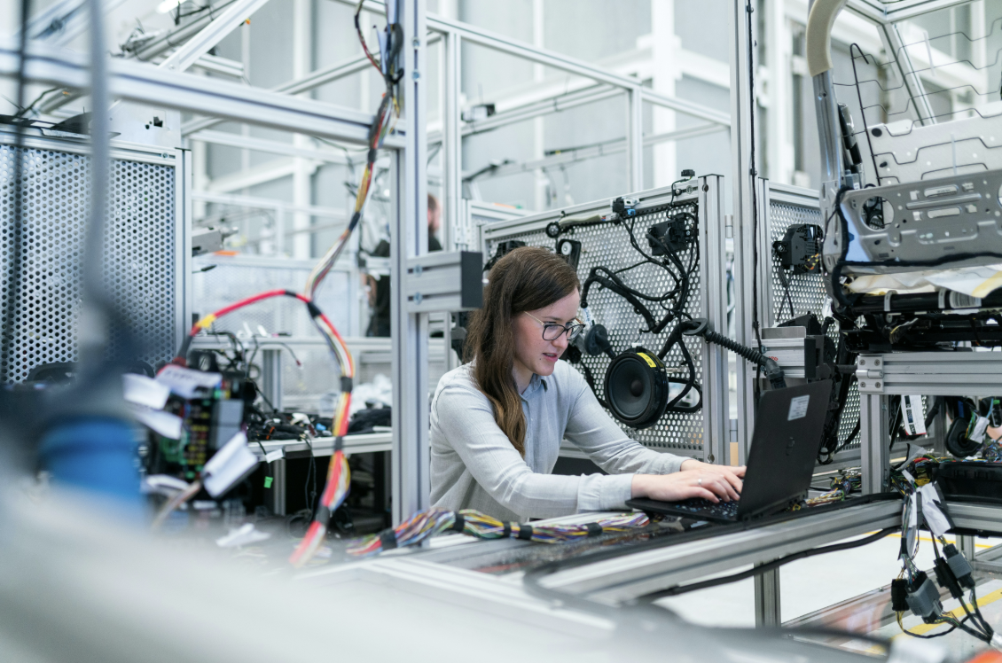 An engineer working on the factory floor of a manufacturing plant